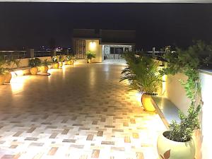 a lobby with potted plants in a building at Hotel Suriyapriya in Cuddalore