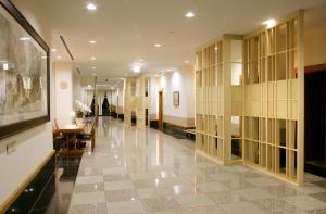 a hallway of a building with a table and chairs at Nakao Kogen Hotel Kazaguruma in Takayama