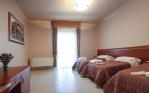 Postel nebo postele na pokoji v ubytování Hotel Ruffirio