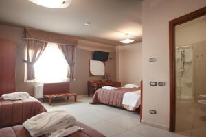 Postel nebo postele na pokoji v ubytování Hotel Ruffirio