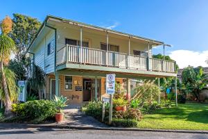 a house with a balcony on top of it at Dunbogan Caravan Park in Dunbogan