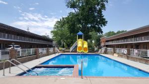 a swimming pool with a slide in a building at South Shore Inn in Sandusky