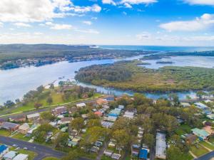 an aerial view of a town next to a river at Dunbogan Caravan Park in Dunbogan