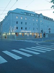 a large building on the corner of a street at Prielmayerhof HOTEL in Linz