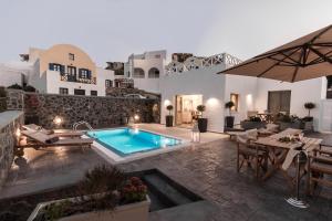 a villa with a swimming pool and a patio at Mathios Luxury Homes in Akrotiri