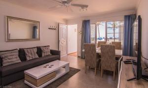 a living room with a couch and a table at Villa Sontrobat in Puerto del Carmen