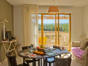 a living room with a table and a couch at Résidence Goélia Le Domaine du Moulin Blanc in Gordes