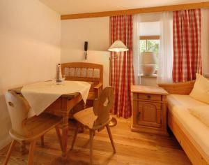 a room with a table and a bed and a bedroom at Gasthof Ochsenwirt in Oberaudorf