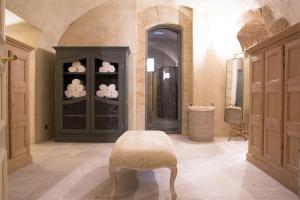 a bathroom with a shower and a stool in a room at Château de Fonscolombe - Relais & Châteaux in Le Puy-Sainte-Réparade +132 photos