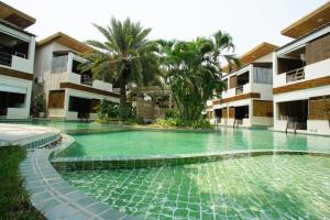 a swimming pool in the middle of a building at The Hideaway Resort in Hua Hin