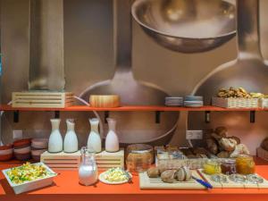 a shelf filled with different types of food at Ibis Riga Centre in Rīga