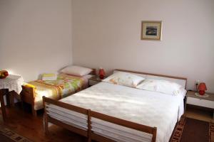 Postel nebo postele na pokoji v ubytování Apartments & Rooms Nada