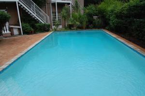 una gran piscina azul frente a un edificio en Falcon Crest Suites en Gaborone