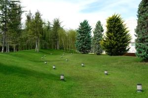 a field with lights in the grass with trees at Finca Prats Hotel Golf & Spa in Lleida
