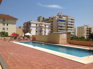 a large swimming pool with buildings in the background at Apartamentos Turísticos Yamasol in Fuengirola