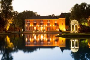 a large house with a pond in front of it at Hôtel du Bois Blanc Domaine d'Epeyssoles Georges Blanc in Vonnas