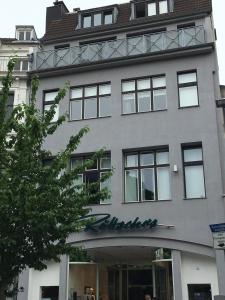 a building with a sign on the side of it at Park Apartaments in Aachen