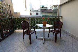 a small table and two chairs on a balcony at Lux Hotel Durante in Milan
