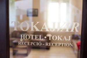 a glass door with the words laxkaar hotel and taloba reception at Tokajv&aacute;r Hotel in Tokaj