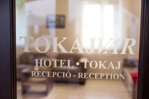 トカイにあるトカイヴァール ホテルのlaxkaar hotelとタロバのフロントの言葉が入ったガラスドア