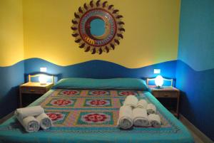 a bedroom with a bed with towels and a mirror at Azzurra Cielomare in Castellammare del Golfo