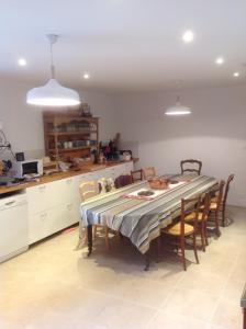 a kitchen with a table and chairs in a kitchen at Le Hameau de Chantemerle in Samoëns