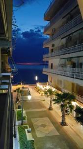 a view of a building at night with palm trees at Apartment Pein 5 in Loutraki