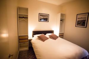 a bedroom with a large white bed in a room at Maison d'O in Ostend