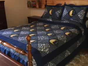a bed with a blue comforter with bananas on it at Apartment in St. Jakob im Rosental in Sankt Jakob im Rosental