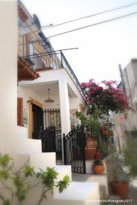 a white house with flowers on the side of it at La Casa di Ivana in San Nicola Arcella