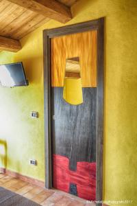 a door to a room with a lamp on the wall at La Casa di Ivana in San Nicola Arcella +37 photos