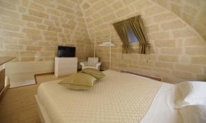 a bedroom with a bed and a tv in a room at Antica Dimora storica La finestra sul campanile in Matera