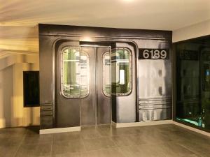 a subway train with its doors open in a building at The Museum Hotel in Nakhon Pathom