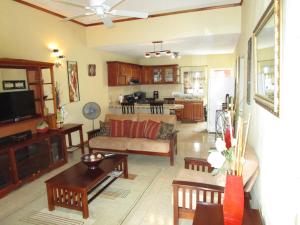 a living room with a couch and a table at The Residence Portmore Apartments in Portmore