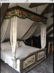 a bed with a canopy with curtains on it at Hotel Jägerhof in Schluchsee