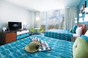 a child laying on a bed in a hotel room at Universal's Cabana Bay Beach Resort in Orlando