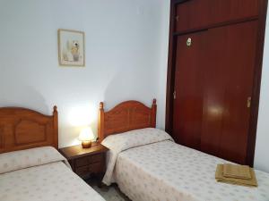 Łóżko lub łóżka w pokoju w obiekcie Playa La Caleta CADIZ Barrio La Viña PARKING GRATIS