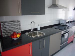 A kitchen or kitchenette at Littore TORMES con Parking, AA y Piscina