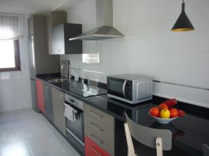 A kitchen or kitchenette at Littore TORMES con Parking, AA y Piscina