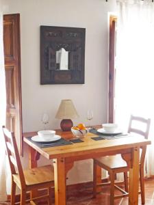 a dining room table with two chairs and a mirror at Casita Buena Vista in Bubión