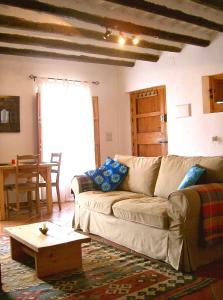 a living room with a couch and a coffee table at Casita Buena Vista in Bubión