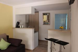 a living room with a couch and a kitchen at AusZeit Nähe Airport in Kleineichen