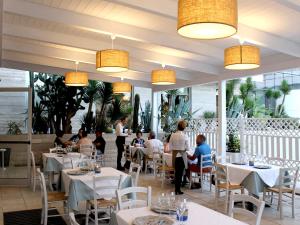 a restaurant with people sitting at tables in a room at Regiohotel Manfredi in Manfredonia