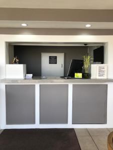 an office counter with a white counter top at Hutchinson Inn in Hutchinson
