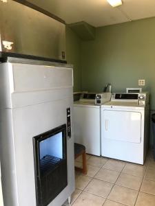 a kitchen with a stove with a fireplace in it at Hutchinson Inn in Hutchinson