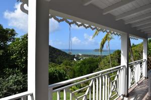a view of the ocean from the porch of a house at Habitation Pineau in Deshaies