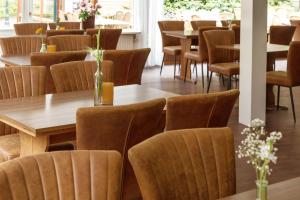 a dining room with wooden tables and chairs at Hotel Restaurant Mondriaan in Winterswijk