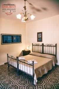 En eller flere senge i et værelse på Hotel Risorgimento
