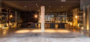 a room with a column and a table in a building at Finca Prats Hotel Golf & Spa in Lleida