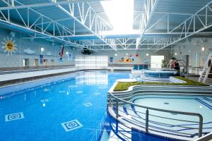 a large swimming pool with blue water in a building at Hotel Westport - Leisure Spa and Conference in Westport